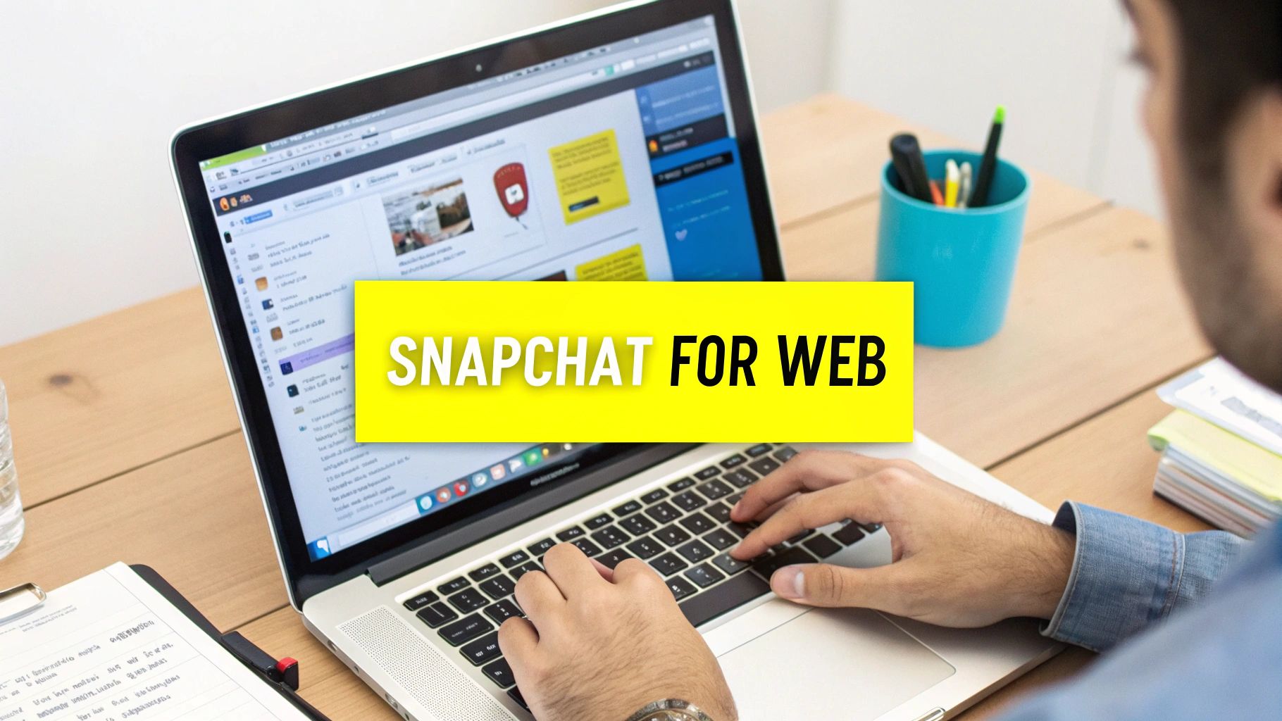 A person types on a laptop displaying "Snapchat for Web", showing the application accessible online.