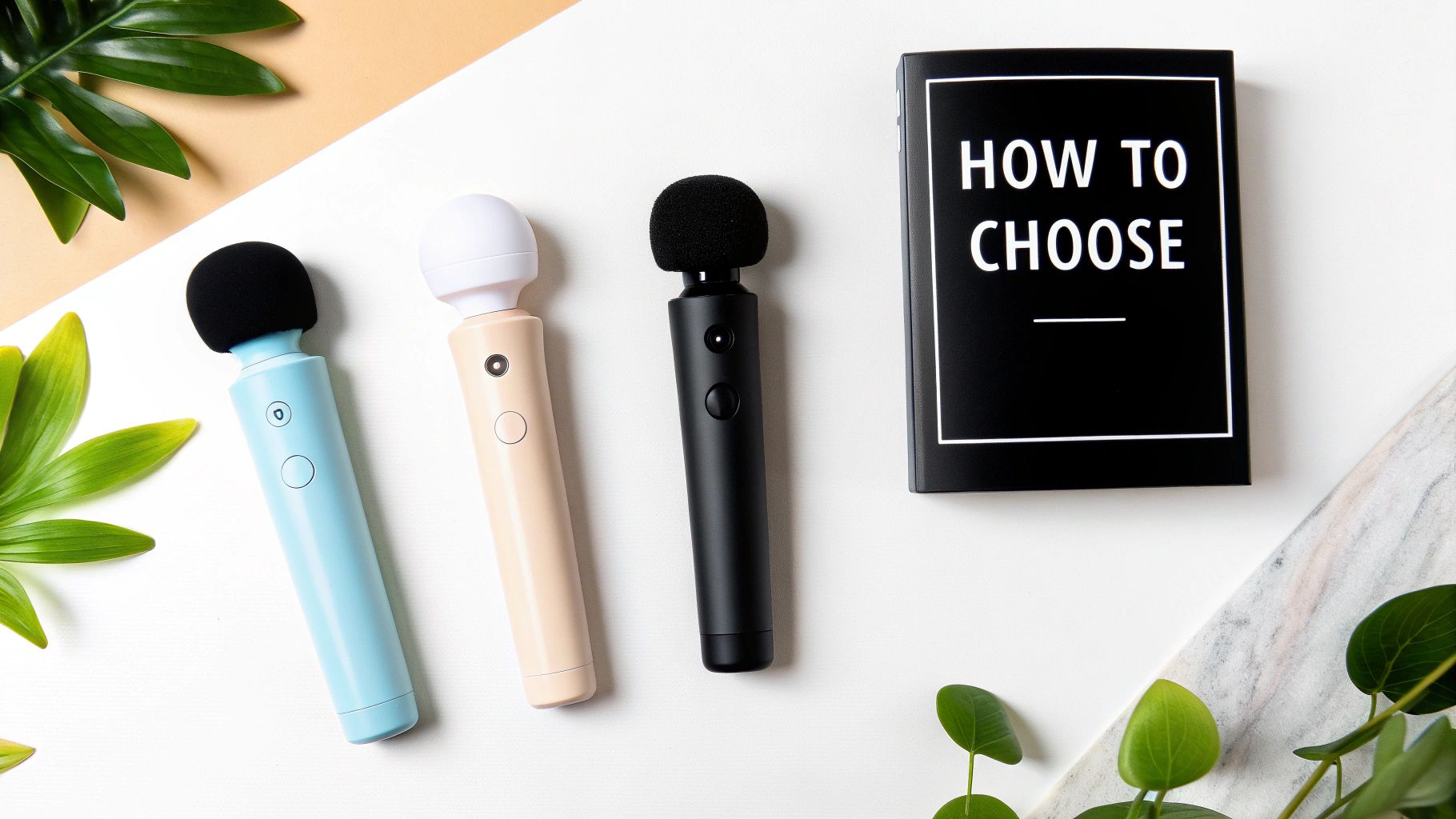 Three different colored wand massagers and a 'HOW TO CHOOSE' guide on a clean desk.