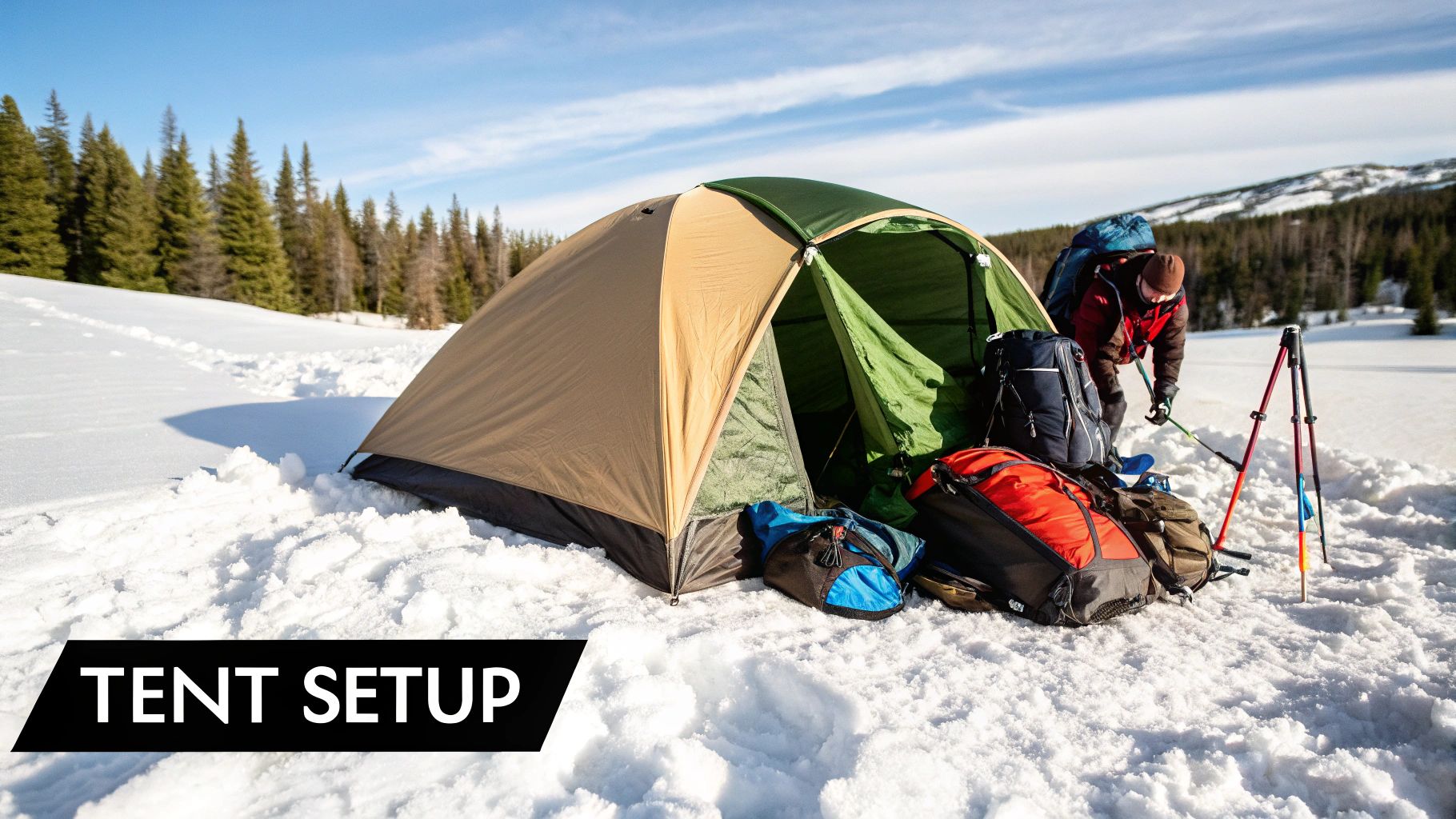 A sturdy four-season tent pitched in a snowy, mountainous environment at dusk.