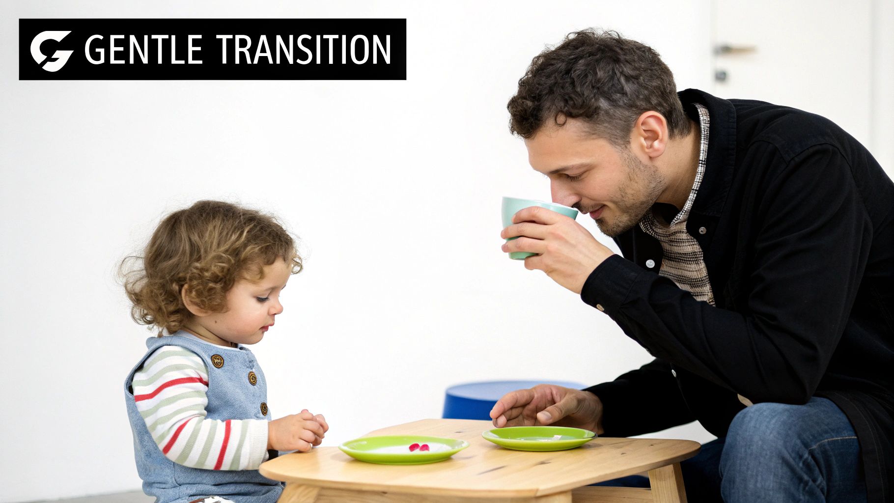 A toddler happily drinking from a sippy cup held by a parent