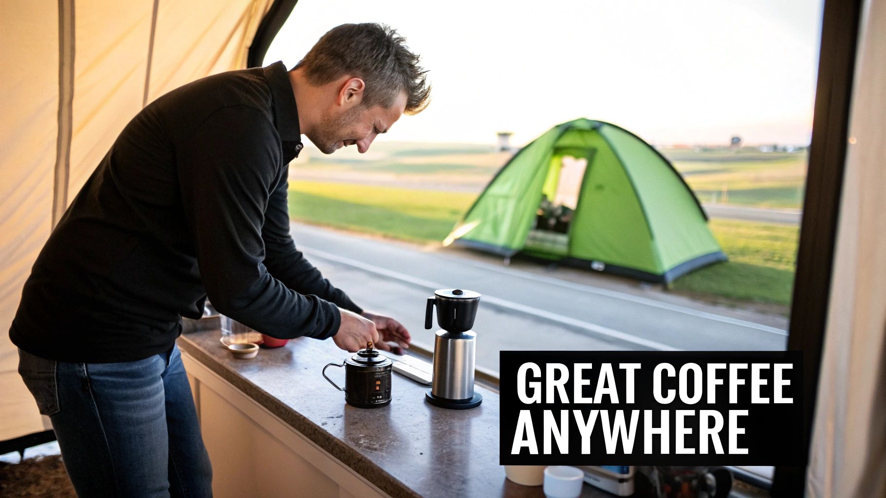 A man prepares coffee inside a camper, with a green tent visible outside in a sunny landscape.