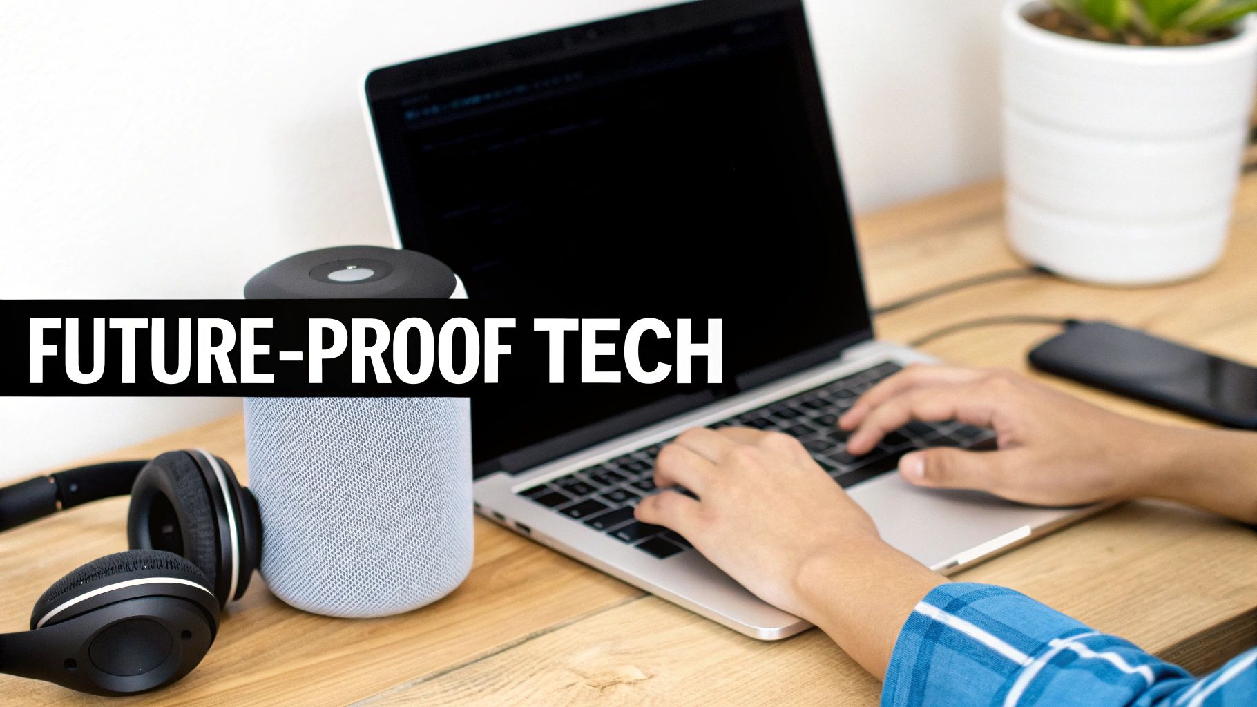 A person types on a laptop next to a smart speaker and headphones on a desk with 'FUTURE-PROOF TECH' text.