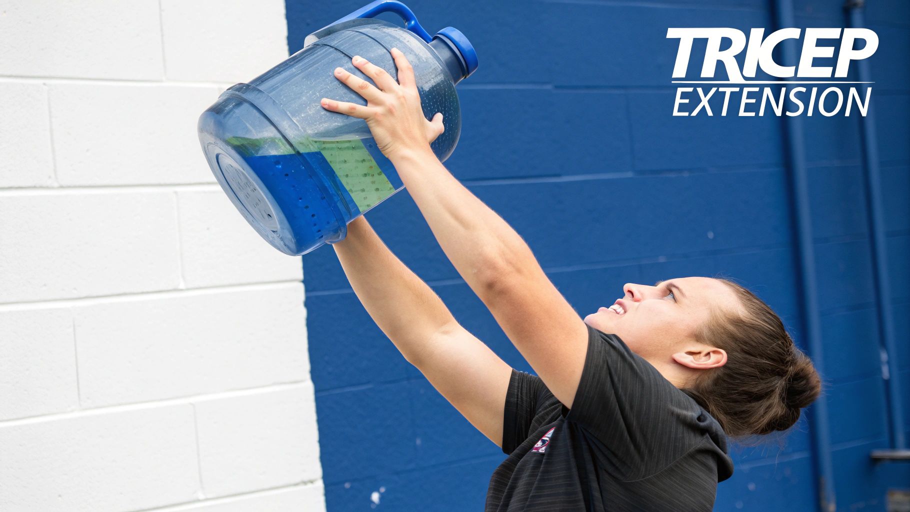 Athlete performing an overhead tricep extension using a water jug at home