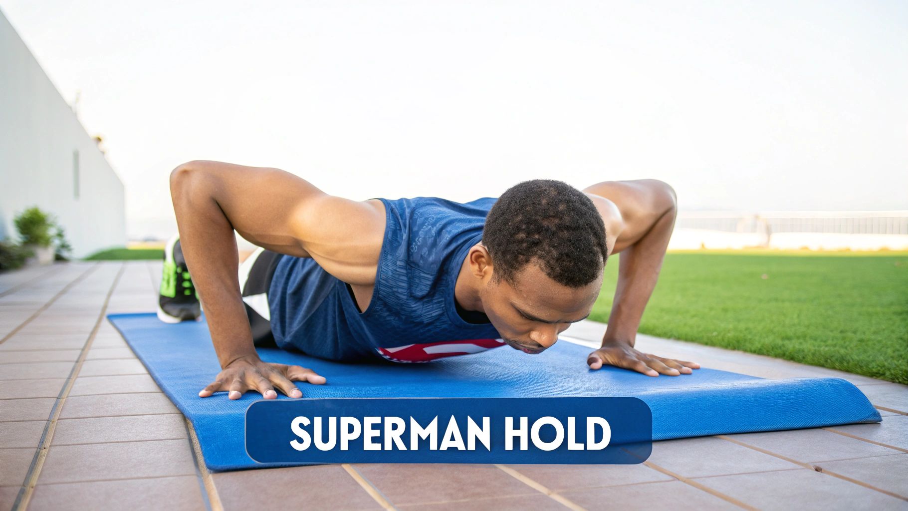 Athlete performing Superman raises on a mat with neutral neck and active glute engagement