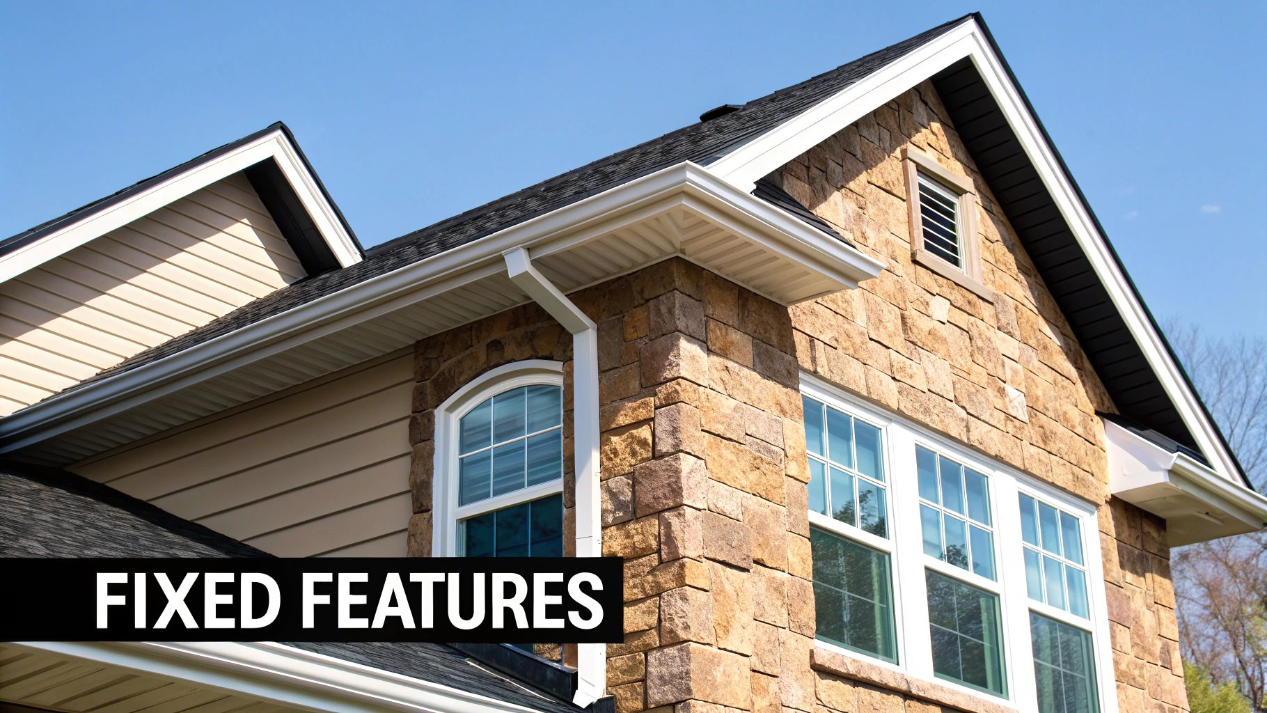 Modern house exterior showcasing stone and beige siding, black roof, white gutters, and windows.