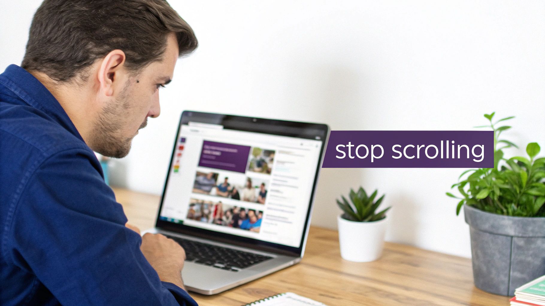 A man in a blue shirt is focused on a laptop screen displaying various images and content.