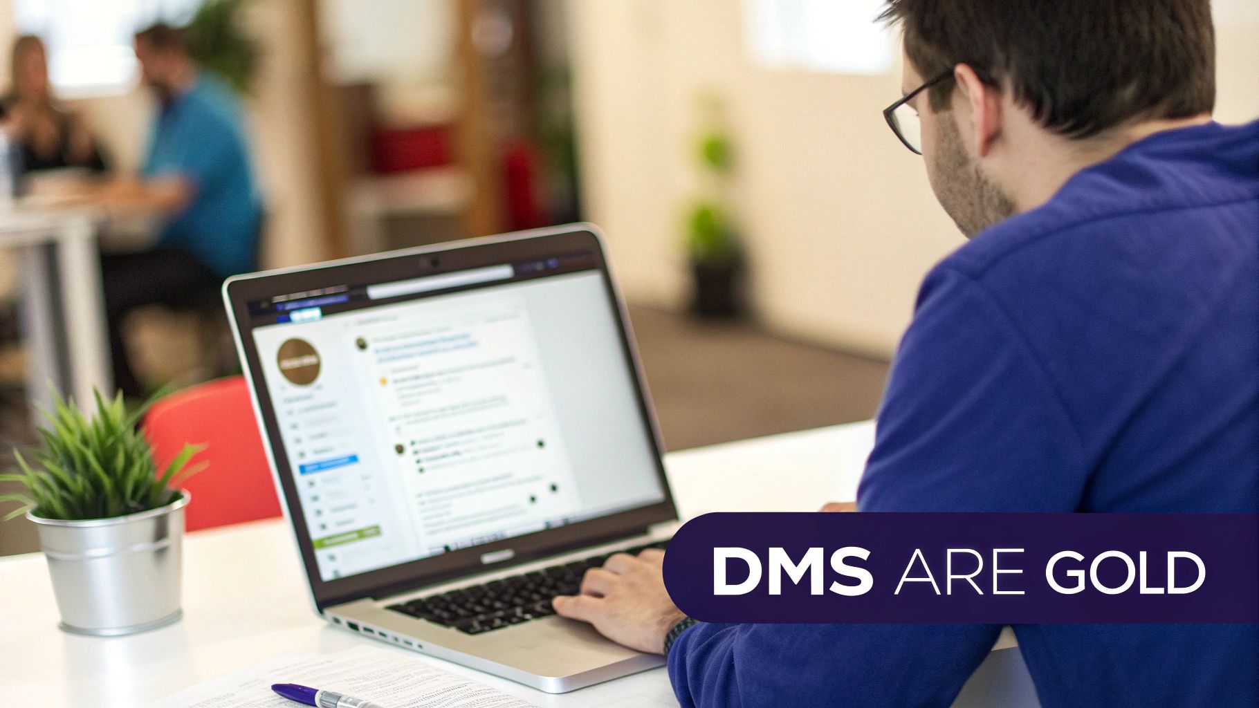 Professional man working on laptop viewing Twitter direct messages in modern office workspace