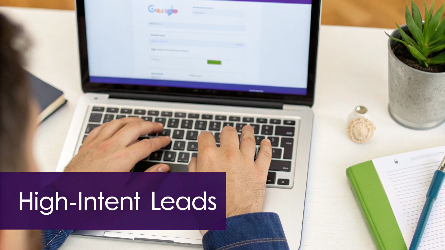 Person typing on laptop computer searching for high-intent leads with hands on keyboard