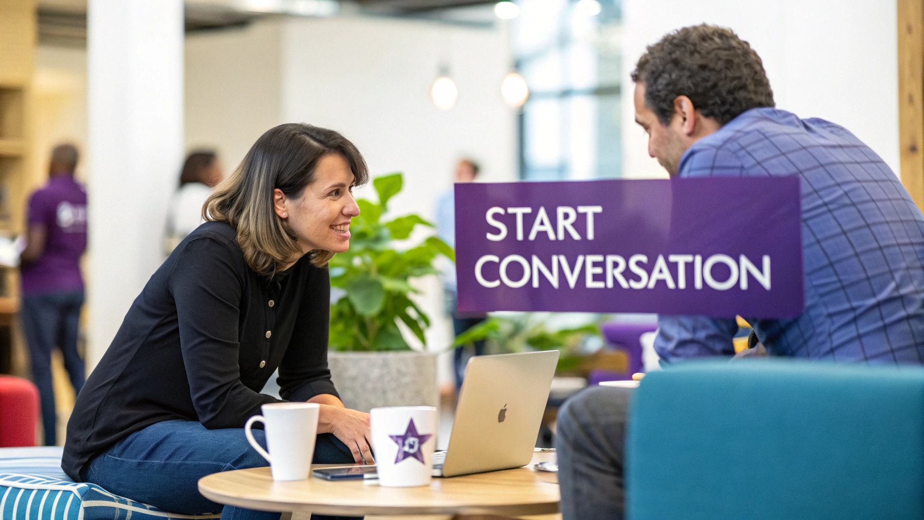 Two professionals engage in a lively conversation at a networking event in a modern office.