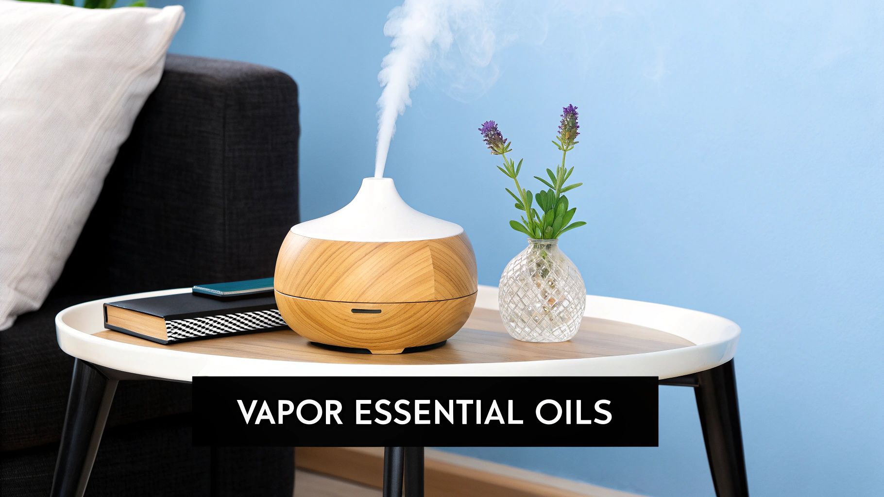 An essential oil diffuser on a table emits vapor next to lavender flowers, a book, and a sofa.