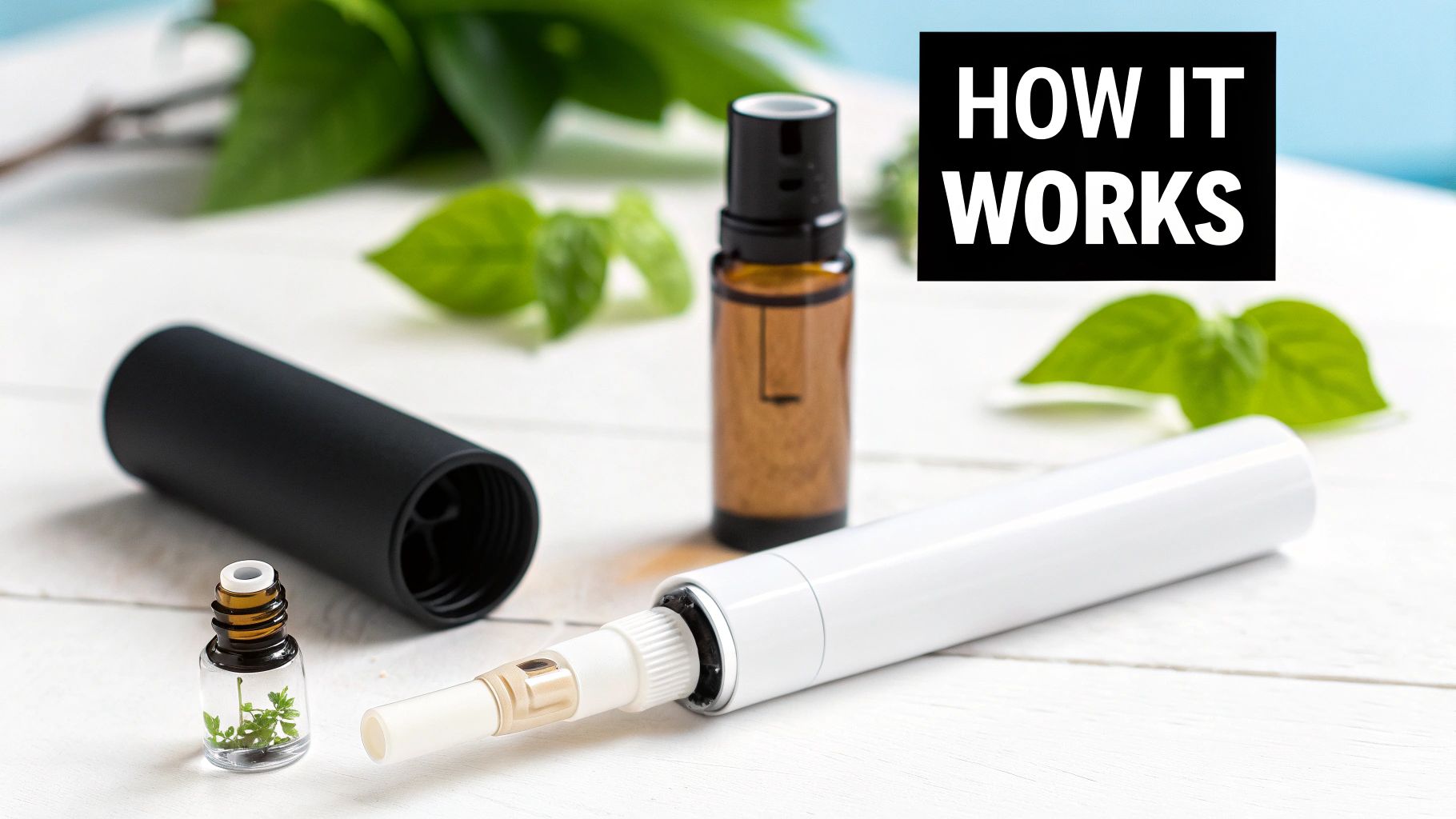 Aromatherapy inhaler pen components, essential oil bottles, and fresh green leaves on a white wooden table.