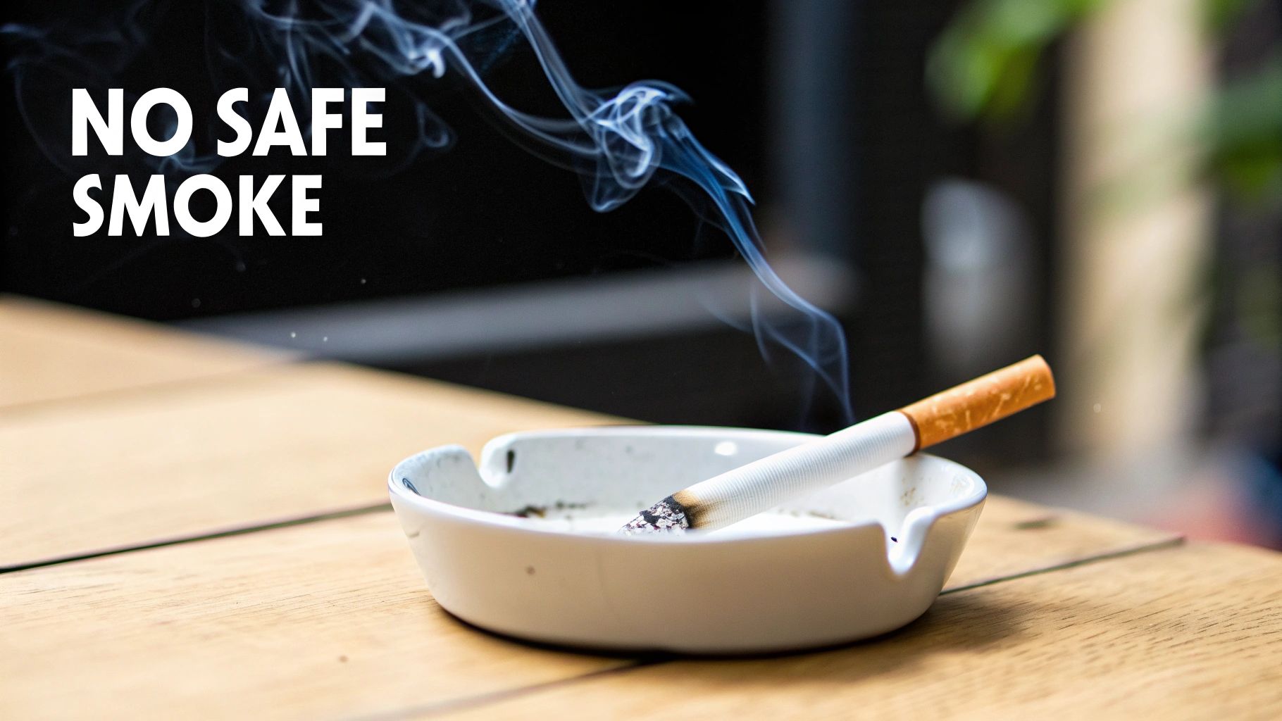 A lit cigarette resting in a white ashtray on a wooden table, emitting smoke, with the text 'NO SAFE SMOKE'.