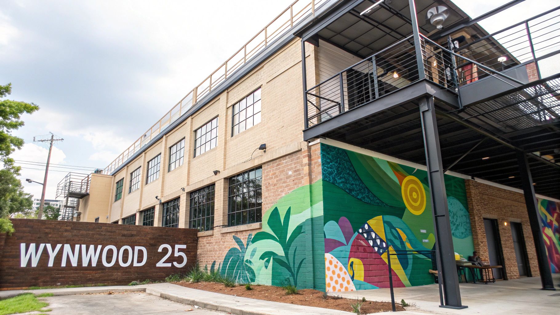 Exterior of Wynwood 25 apartment building with its distinctive architecture and artful design