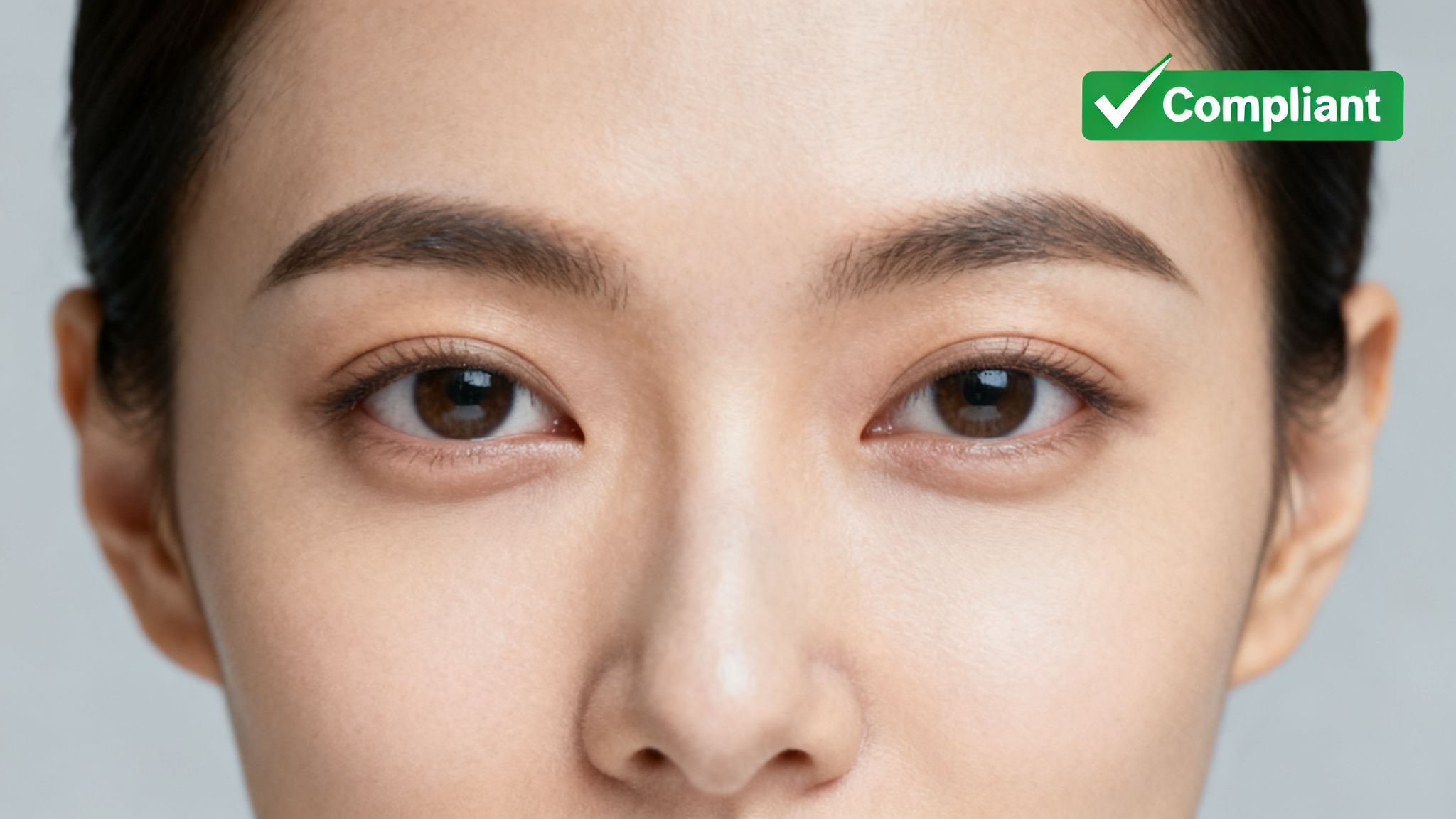 A Complete Guide to UK Passport Photo Size and Requirements 23 Close-up of a person's face showing brown eyes and dark eyebrows, compliant for official identification.