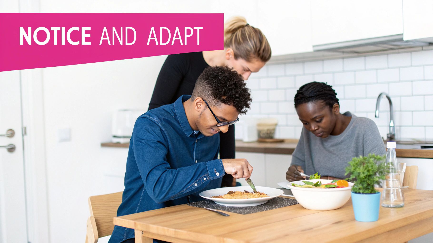 Three people eating together at a wooden table in a modern kitchen, focusing on their meal.
