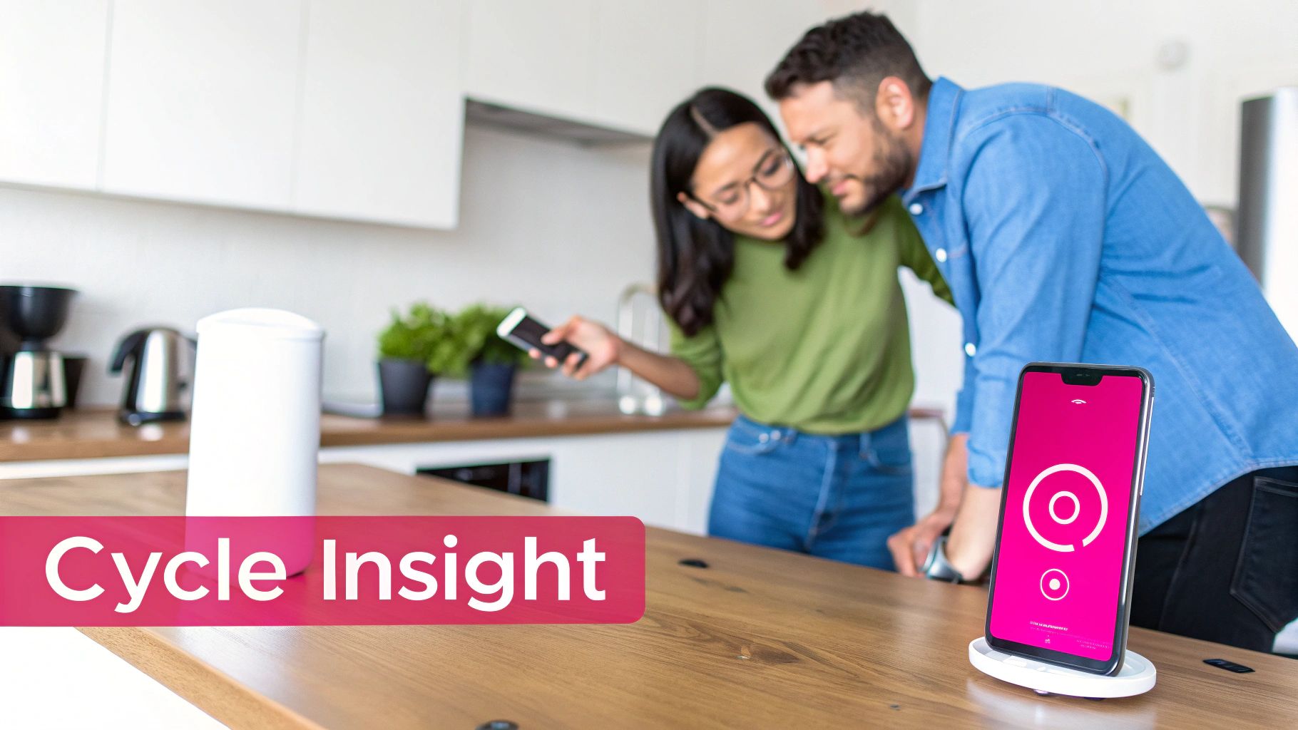A couple in a modern kitchen using smartphones, one displaying a cycle tracking app.