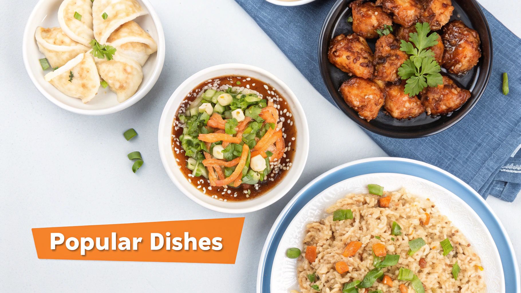 Overhead view of various popular Chinese dishes, including dumplings, fried chicken, fried rice, and a vegetable salad.