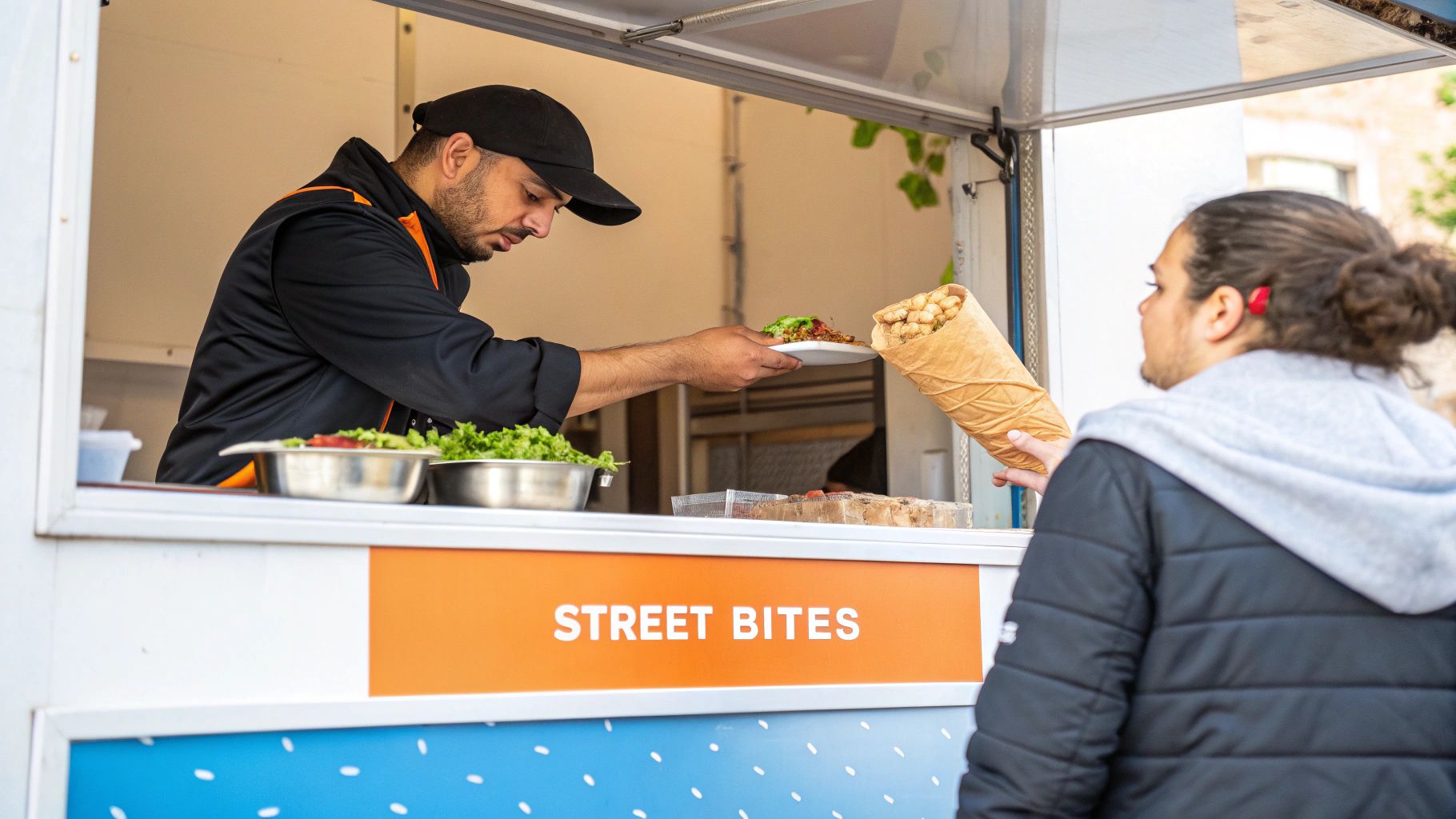 A food vendor serves a plate of street food to a customer at a 'Street Bites' food stall.