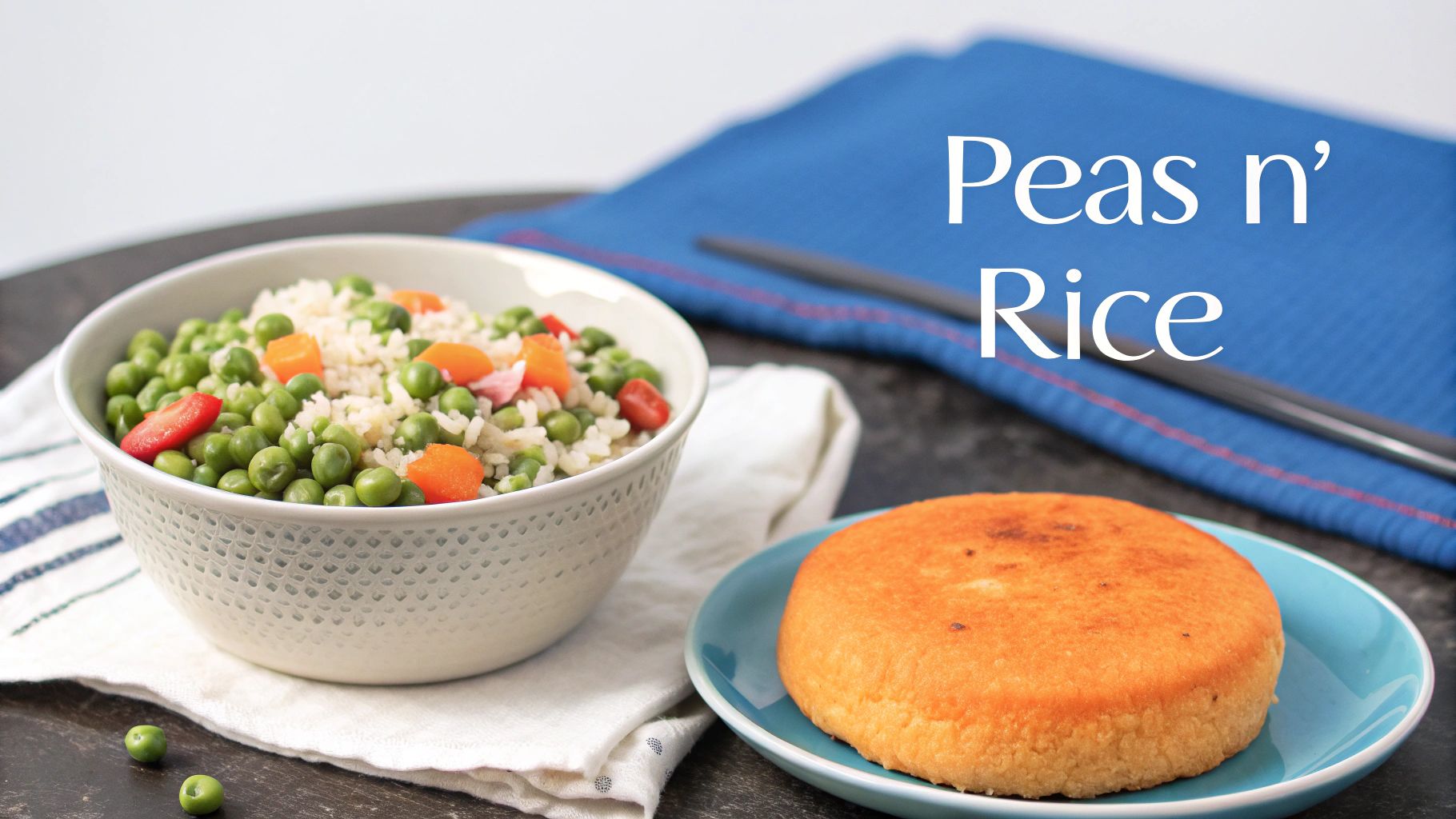 A vibrant image of Bahamian peas and rice in a bowl, served with a golden johnnycake on a blue plate.
