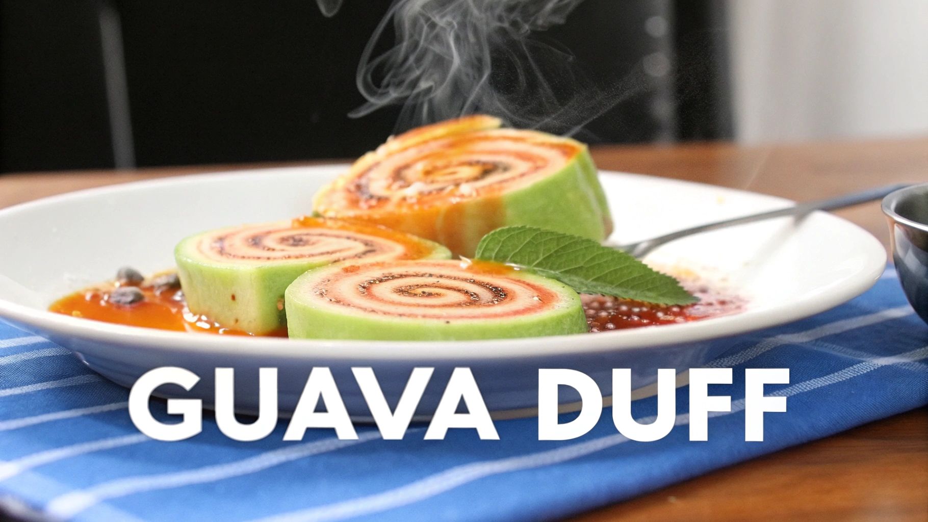 Three steaming slices of guava duff dessert, showing green skin and pink spiral filling, with sauce and mint.