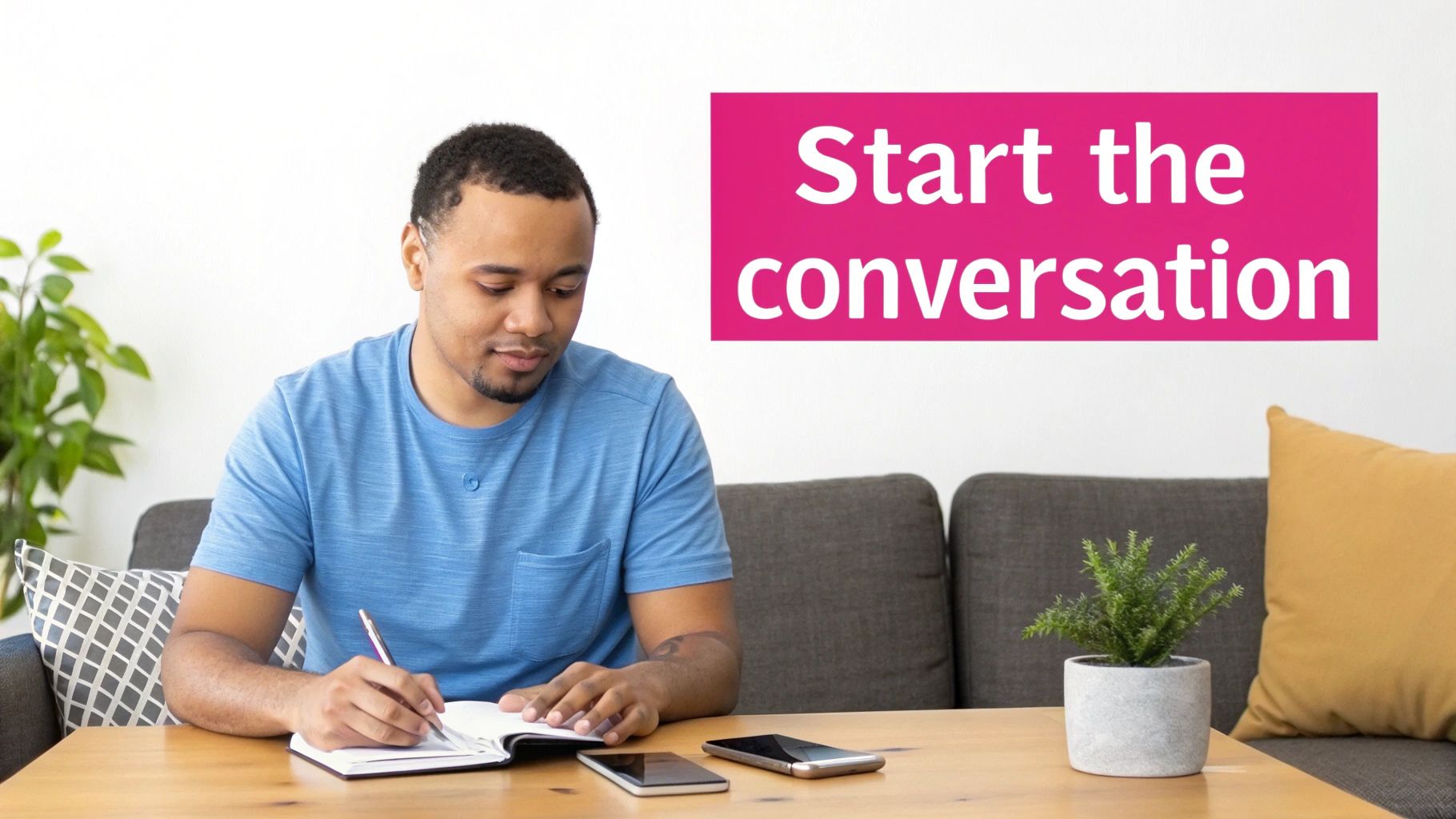 A man in a blue shirt writing in a notebook at a table with phones, beside 'Start the conversation' text.