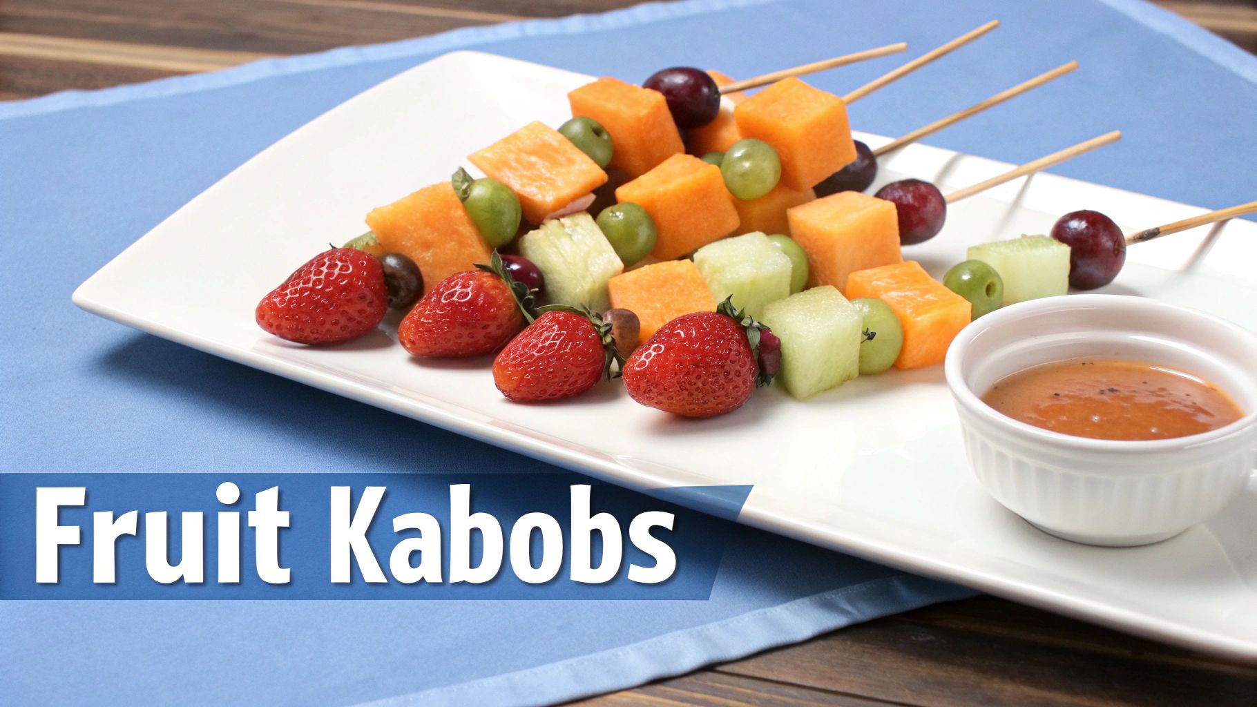 Colorful fruit kabobs with strawberries, cantaloupe, honeydew, and grapes on skewers, served with dipping sauce.