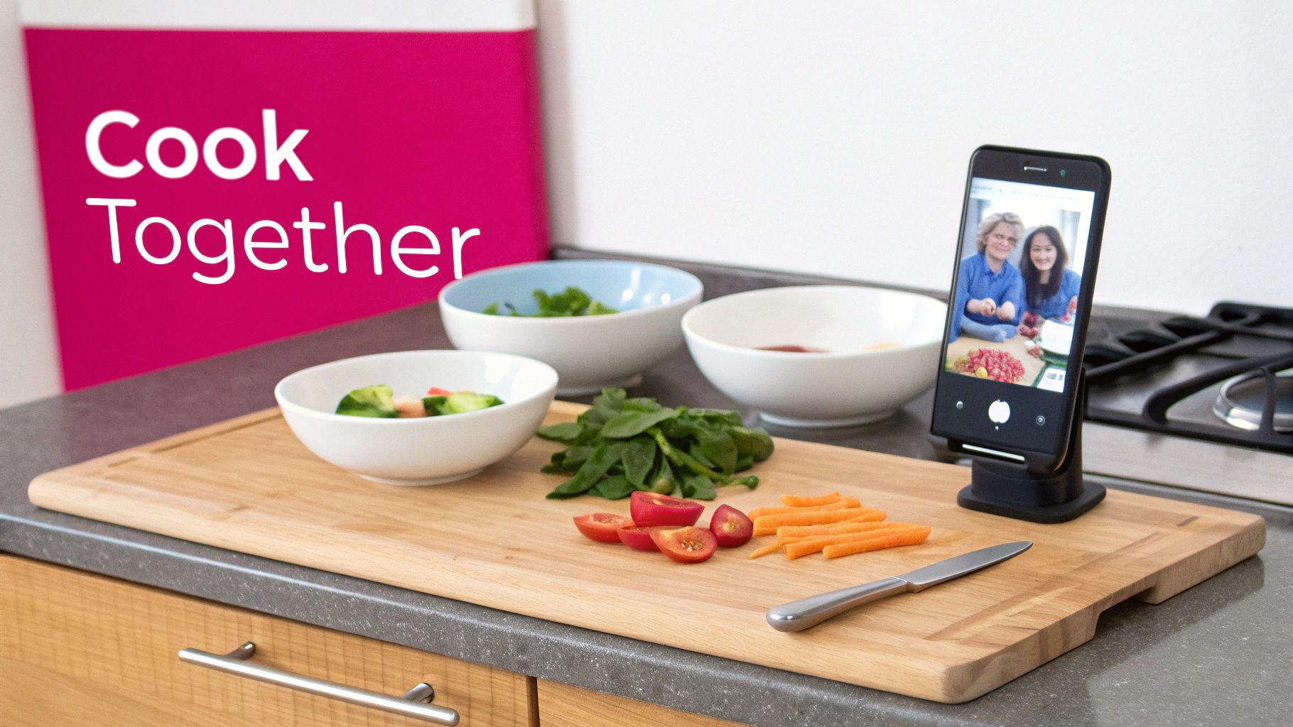 A kitchen counter with cooking ingredients, a smartphone showing a video call of two people cooking.