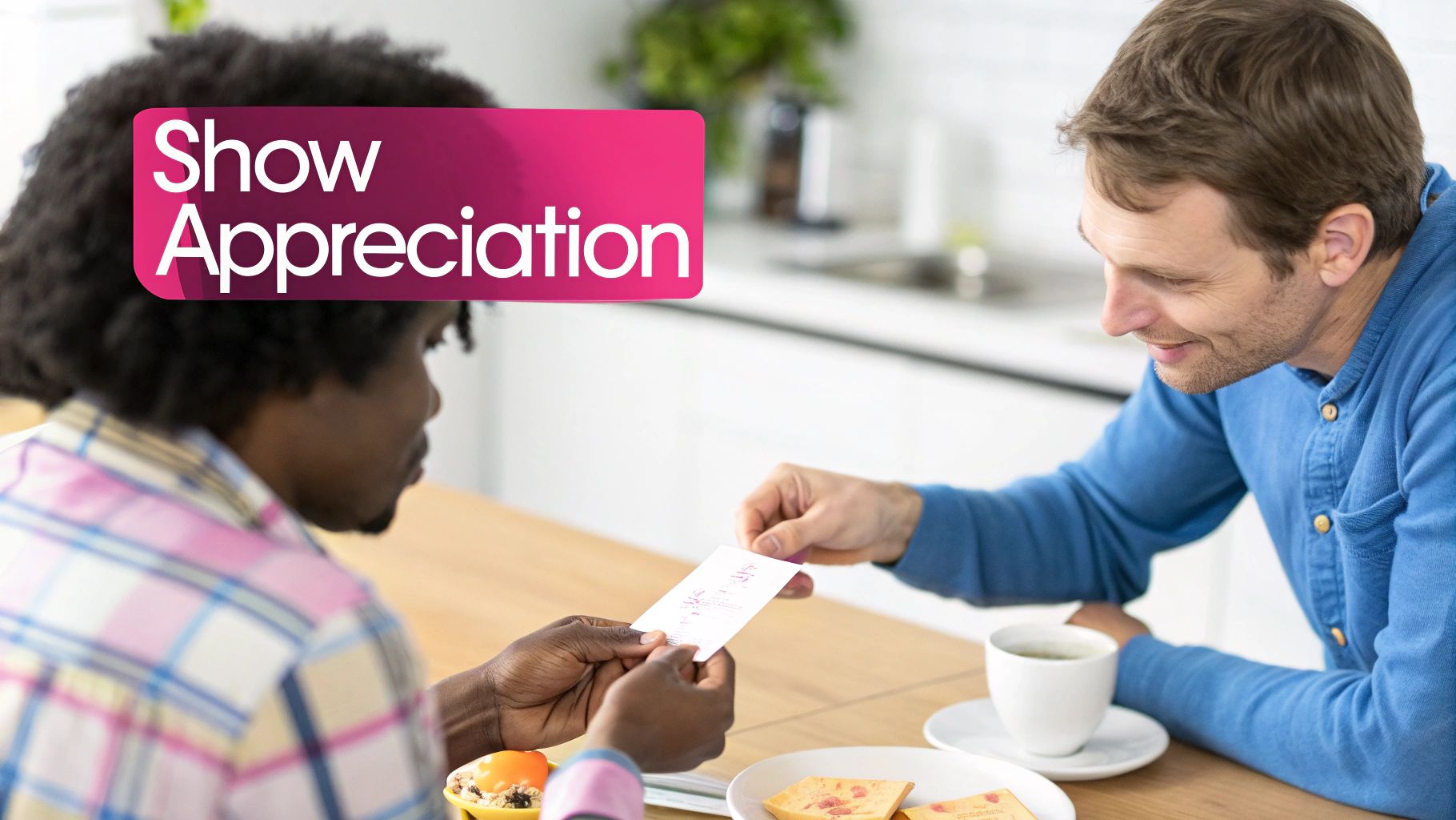Two smiling men exchanging a card at a table, with a 'Show Appreciation' banner.
