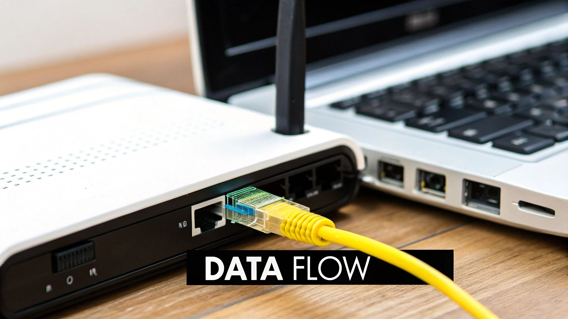 Close-up of a white modem/router connected to a laptop with a yellow Ethernet cable, indicating data flow.