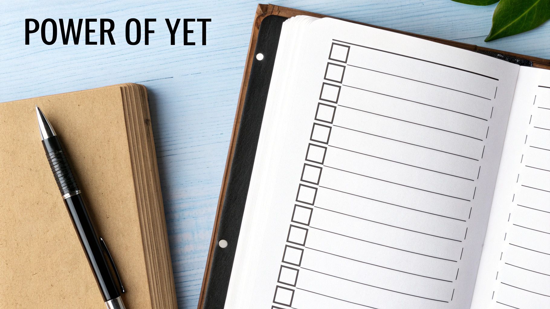 Open planner with 'POWER OF YET' text, a pen, and a checklist, promoting growth mindset.