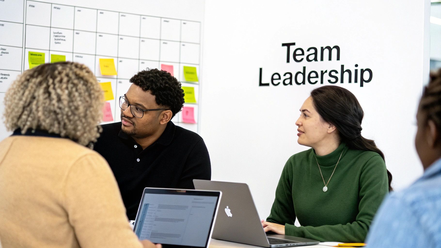 A development team collaborating around a whiteboard, sketching out software architecture.