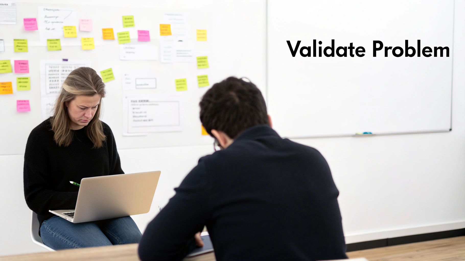 A team collaborating around a new product with sticky notes and diagrams.