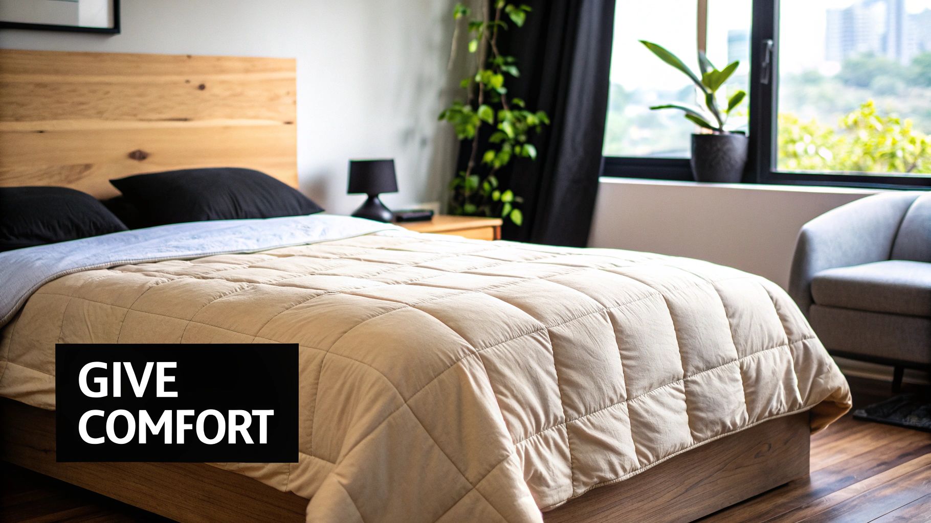 A cozy bedroom featuring a wooden bed, black pillows, and a beige comforter, with a window view.