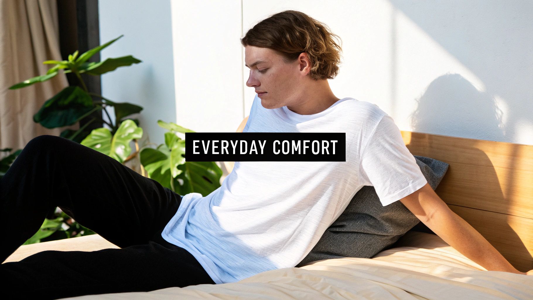 A person comfortably sleeping in a bed with soft, light-coloured cotton jersey sheets.