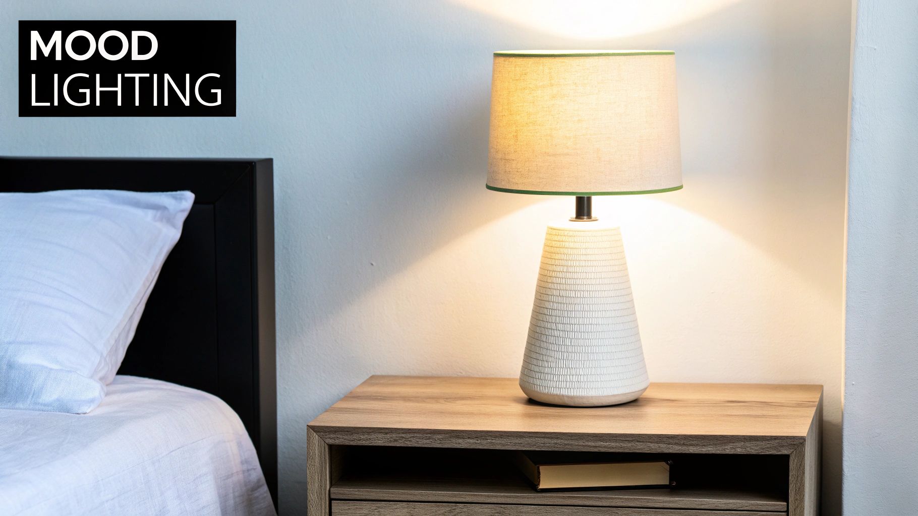 A bedside table with a glowing lamp and a book, next to a bed with a white pillow, labeled 'MOOD LIGHTING'.