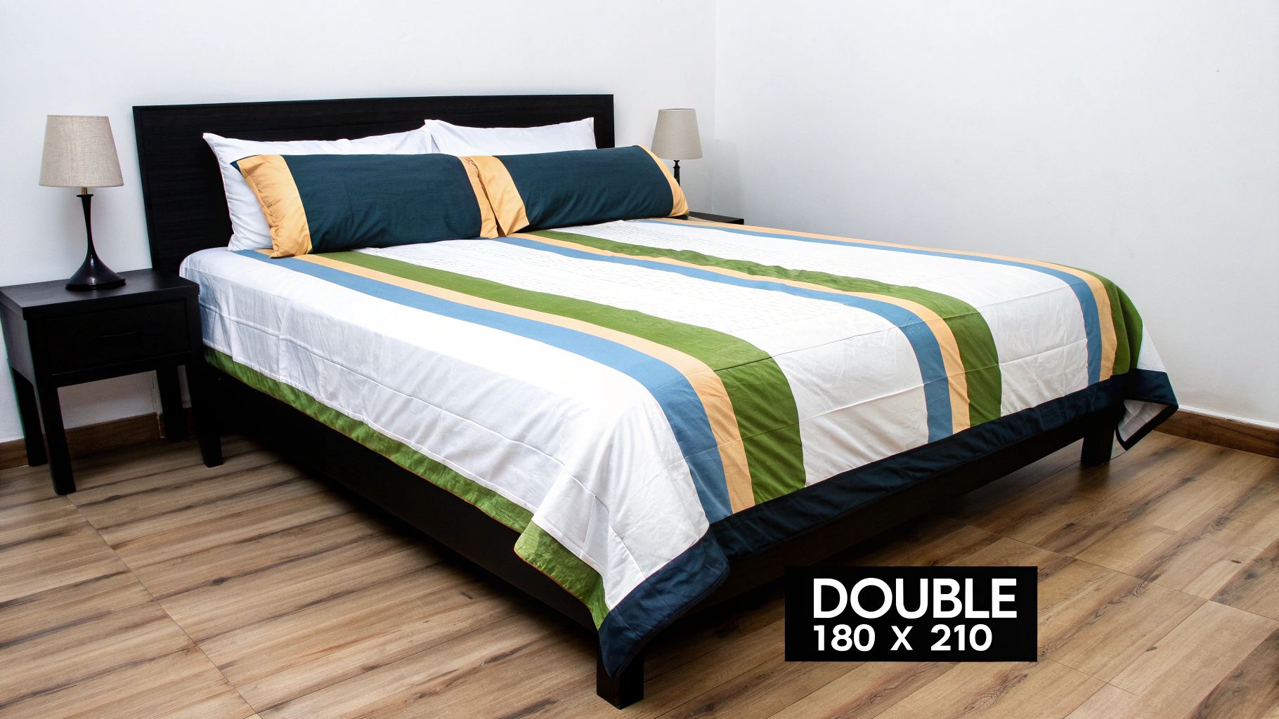 A neatly made double bed with a grey quilt cover, showcasing a perfect fit.