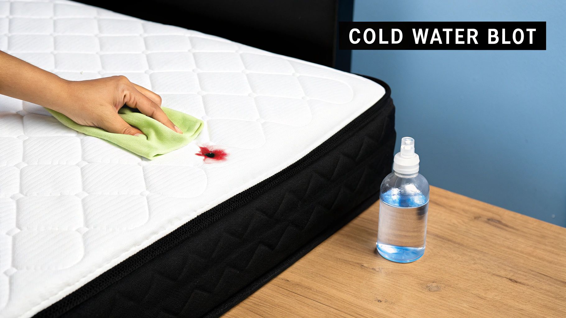A person blotting a mattress stain with a white cloth.