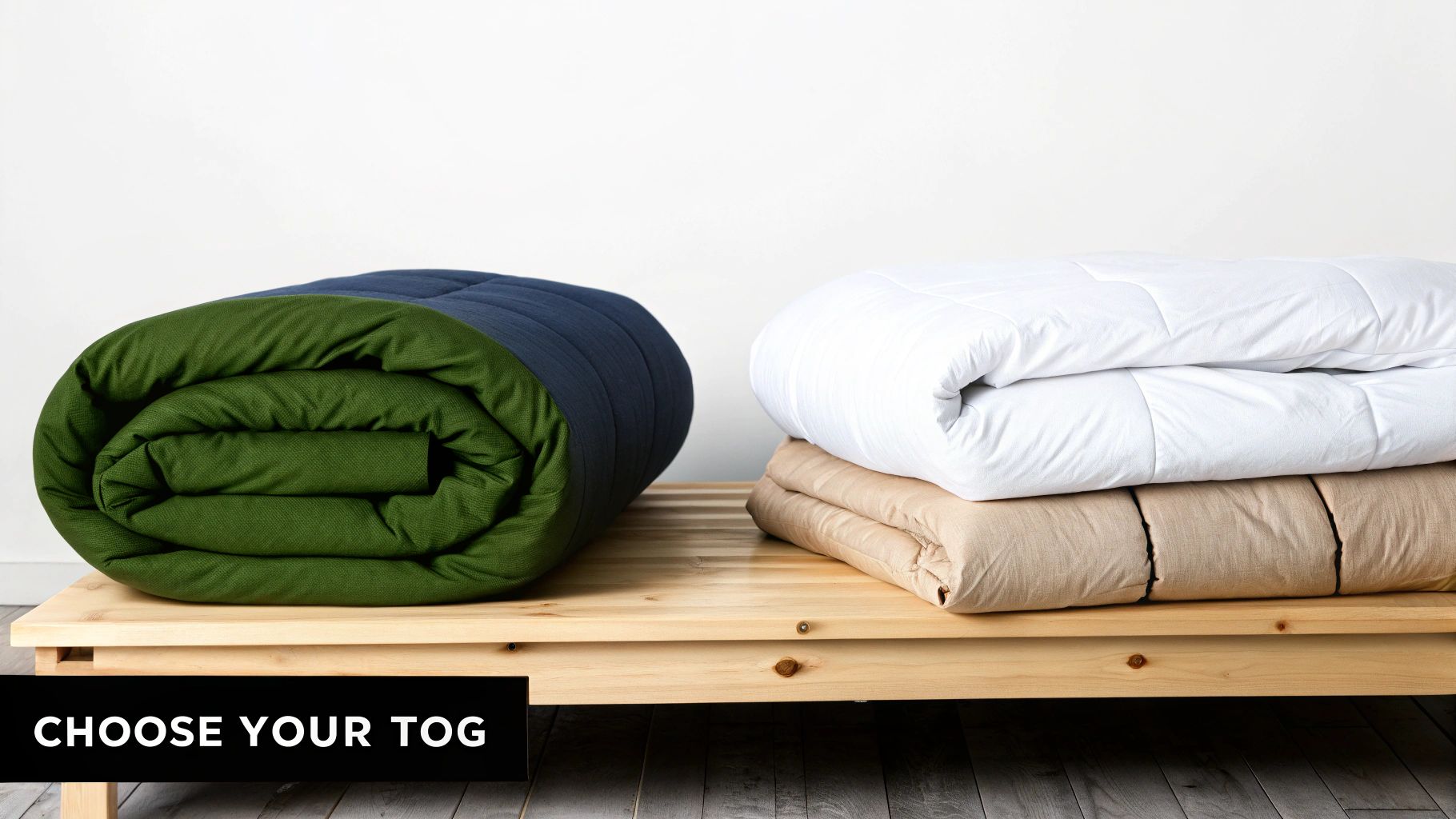Assortment of duvets in various colors (green, blue, white, beige) displayed on a wooden bed frame.