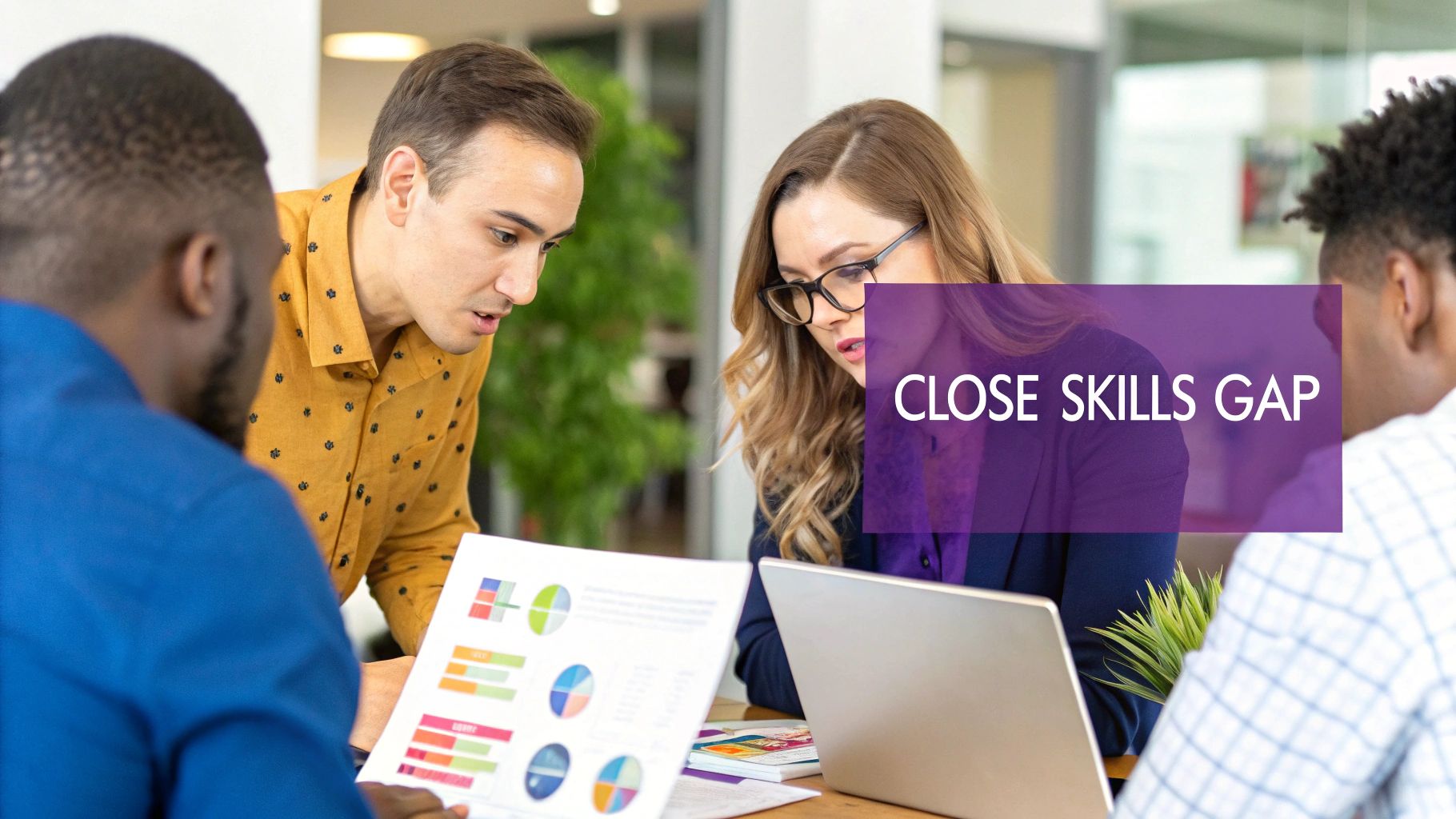 Diverse team collaborating on a skills gap analysis, reviewing charts and data in a modern office.