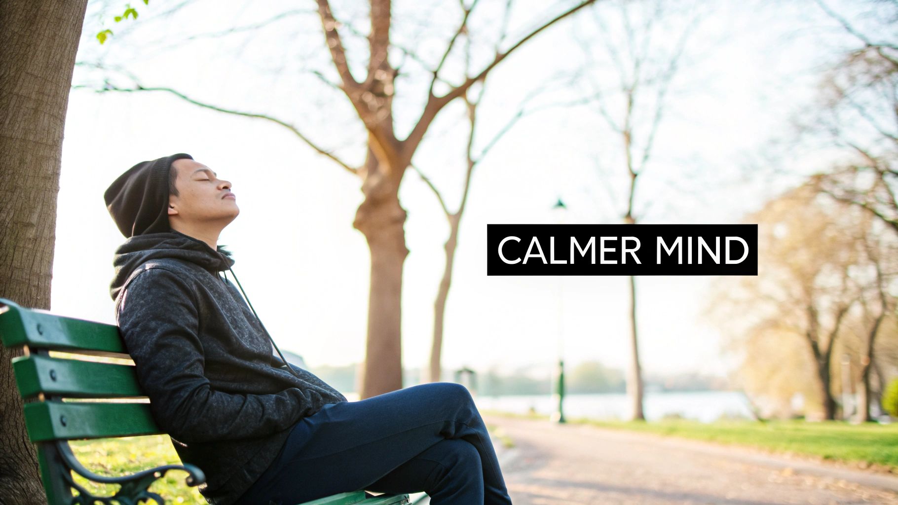 Person relaxing on park bench outdoors with eyes closed practicing mindfulness and mental wellness