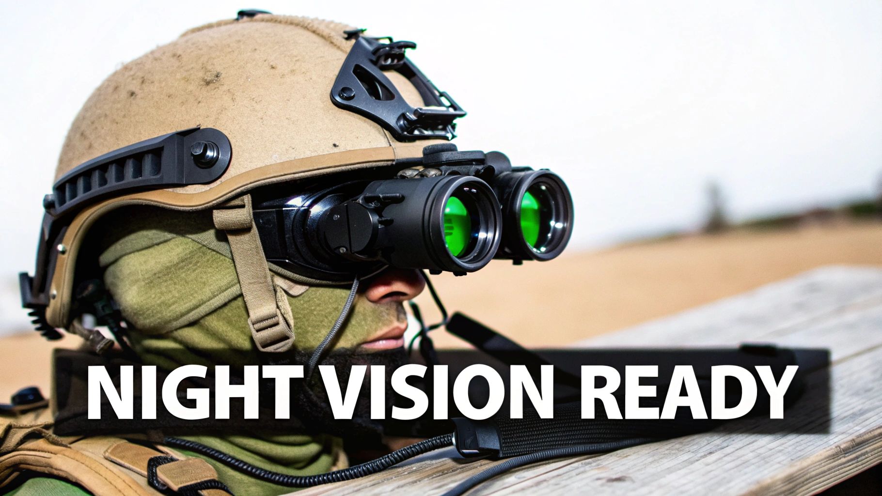 A soldier wearing a tan tactical helmet with green night vision goggles mounted on the front.