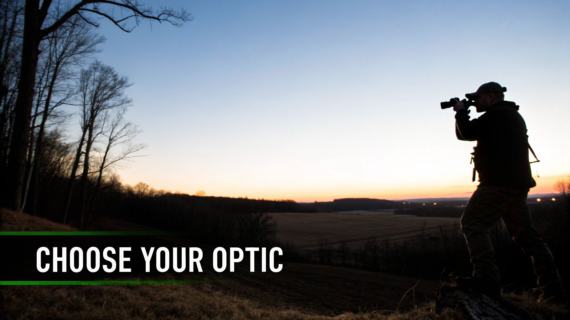 Man in silhouette using optics at dusk, looking over a vast landscape with trees.