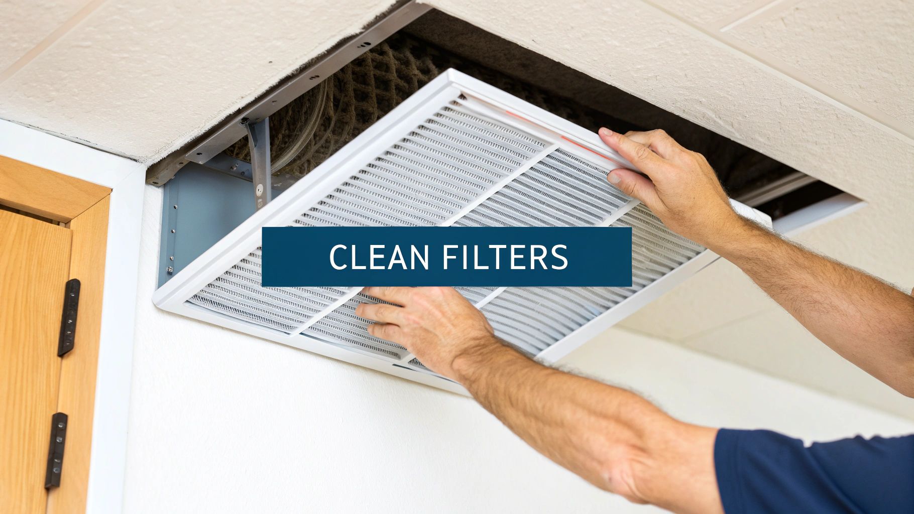 A person cleaning the fins of an outdoor air conditioning unit with a hose.