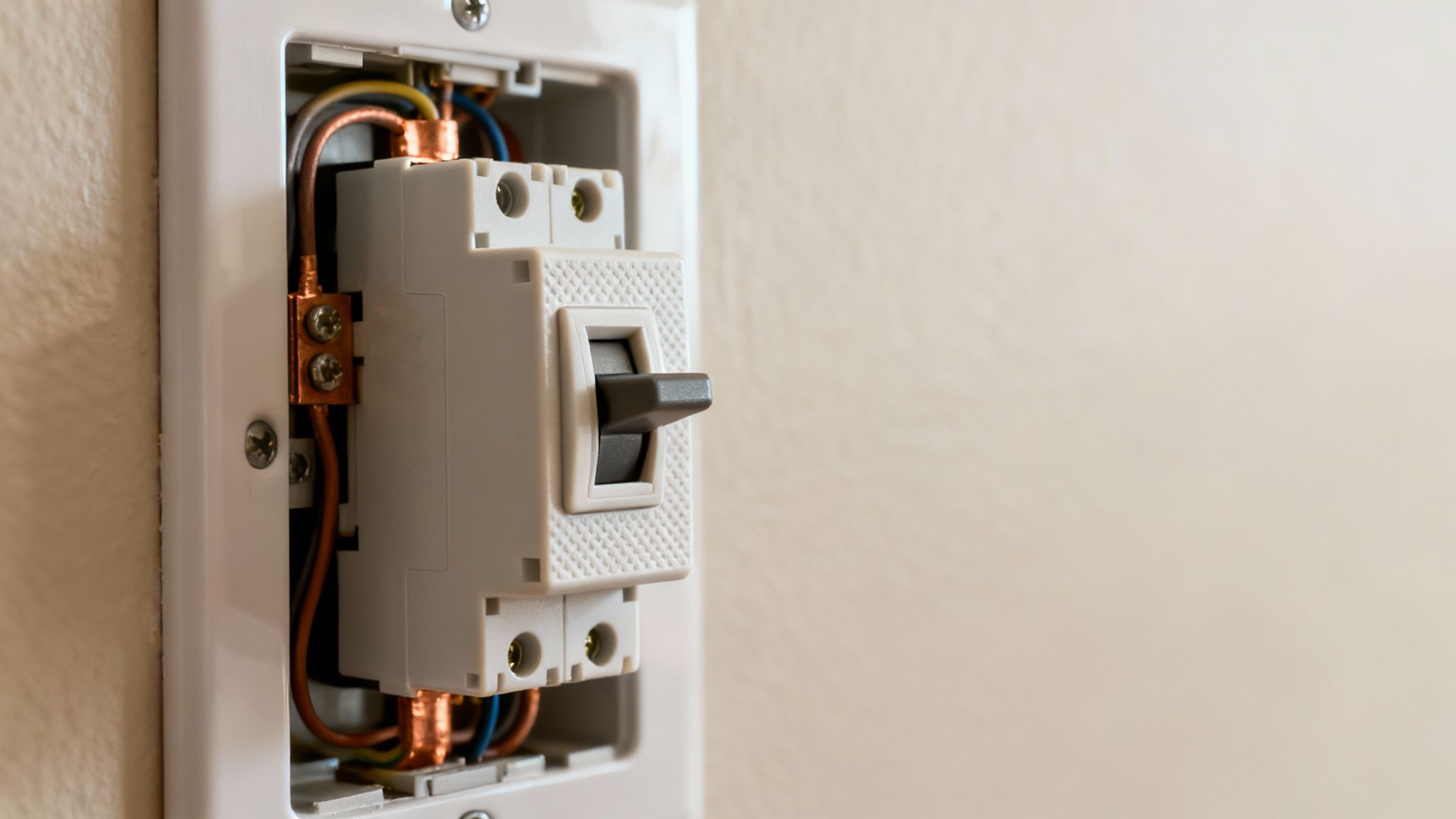 Exposed Electrical Circuit Breaker With Visible Copper Wiring Installed In A Wall.