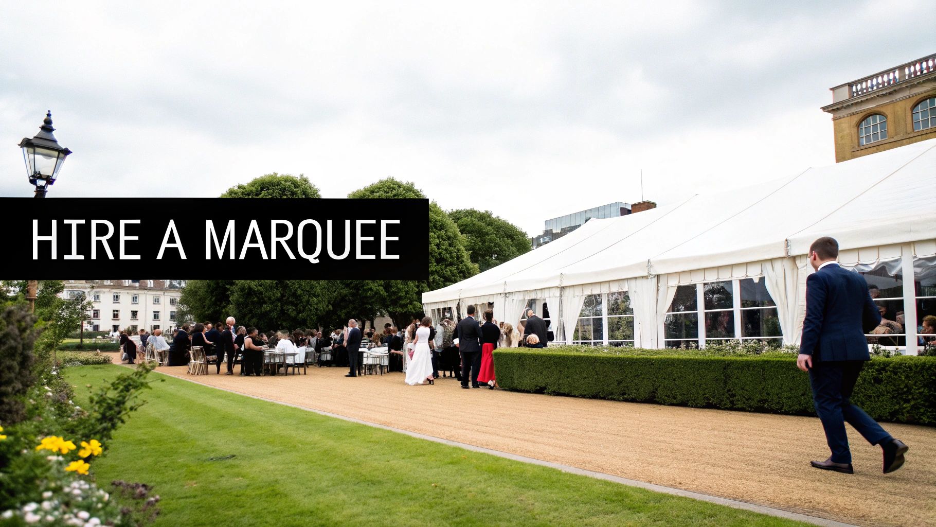 Outdoor marquee event with guests dining and socializing, featuring a large white tent, lush greenery, and a pathway, emphasizing the flexibility of marquee hire for memorable celebrations in London and Croydon.