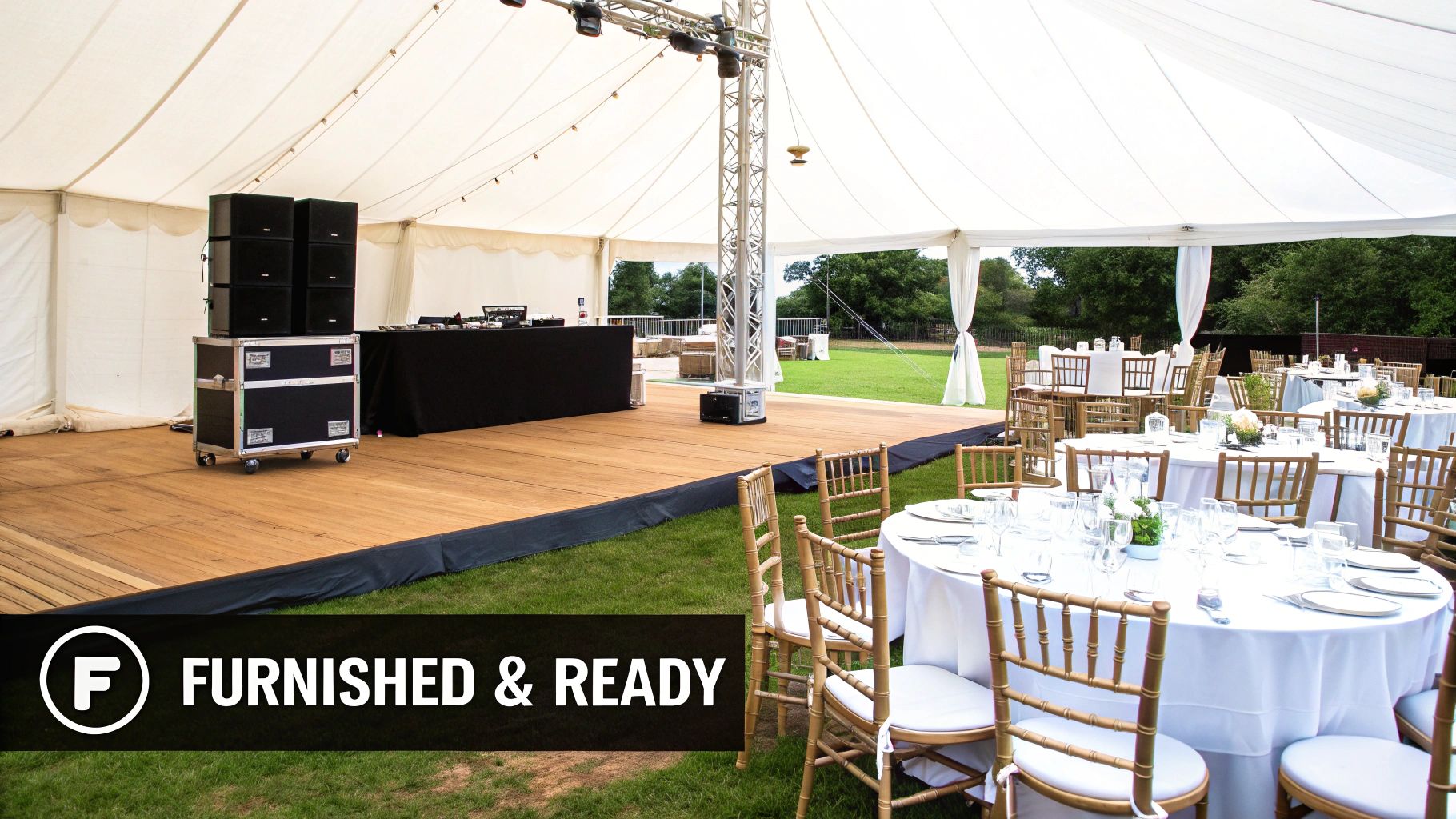 A large white event marquee with a wooden dance floor, DJ setup, and elegant tables set for guests.