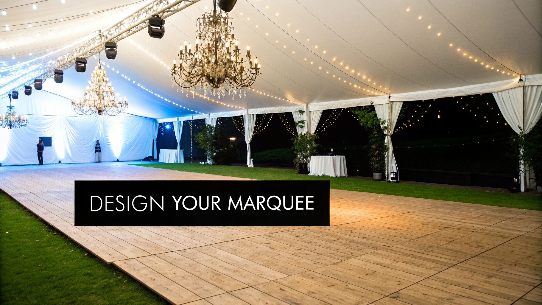 A beautifully decorated event marquee interior featuring a wooden dance floor, elegant chandeliers, and warm string lights.