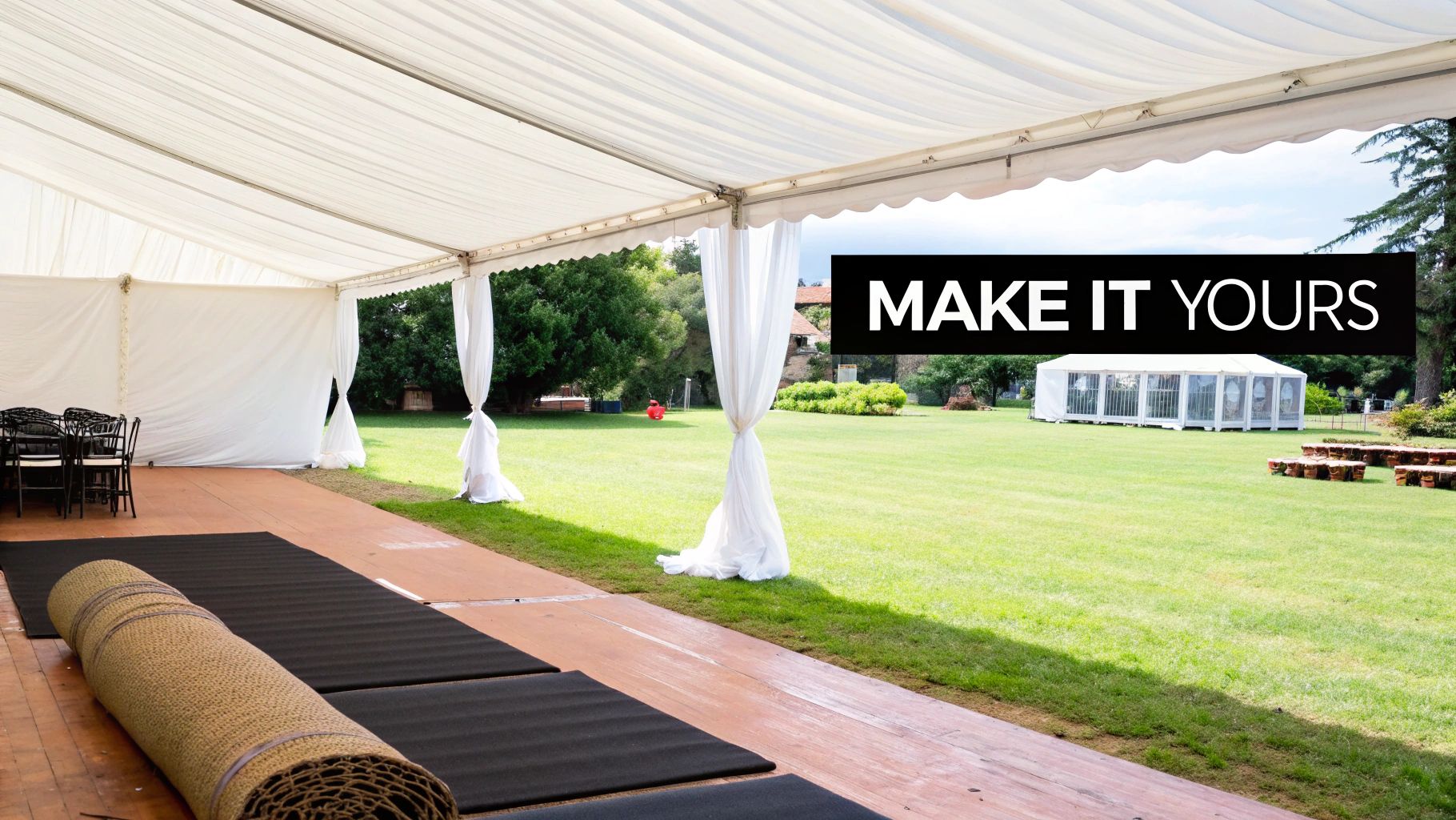 Marquee interior setup with white draping, black chairs, and rolled matting, showcasing a blank canvas for personalized wedding decorations.