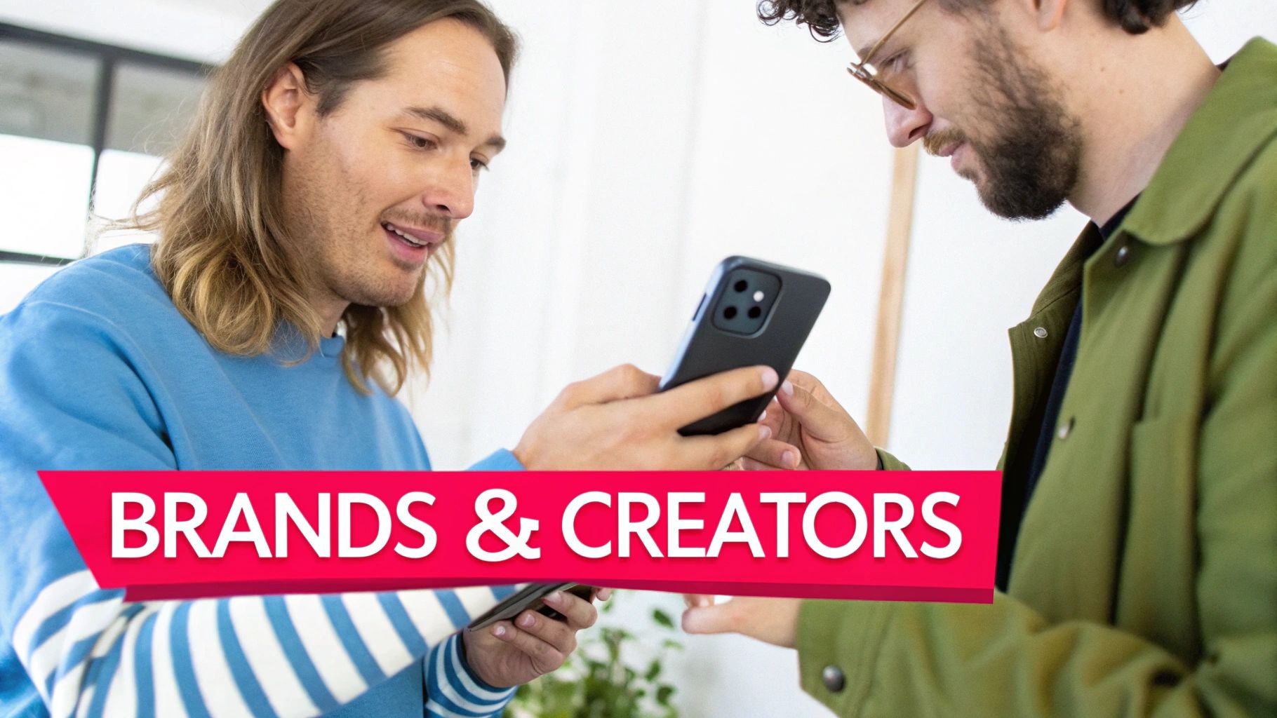 Group of creators collaborating and looking at a laptop, illustrating the benefits of a creator marketplace