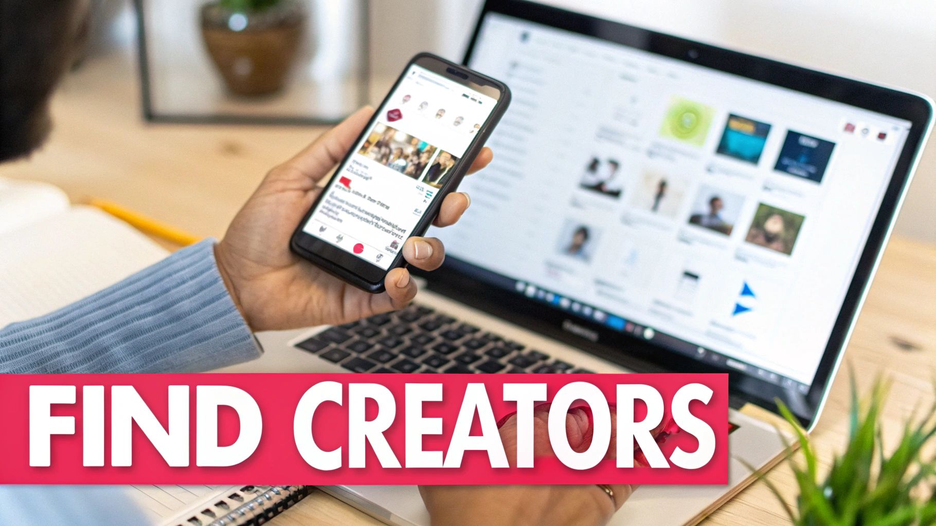 A person holds a smartphone while looking at a laptop screen, both displaying creator profiles and content.